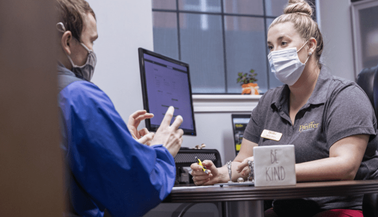 woman talking to man in office