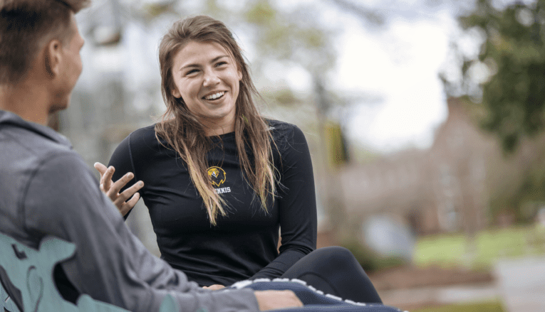 woman smiling and talking sitting outside