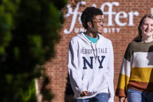 Three students walking on campus