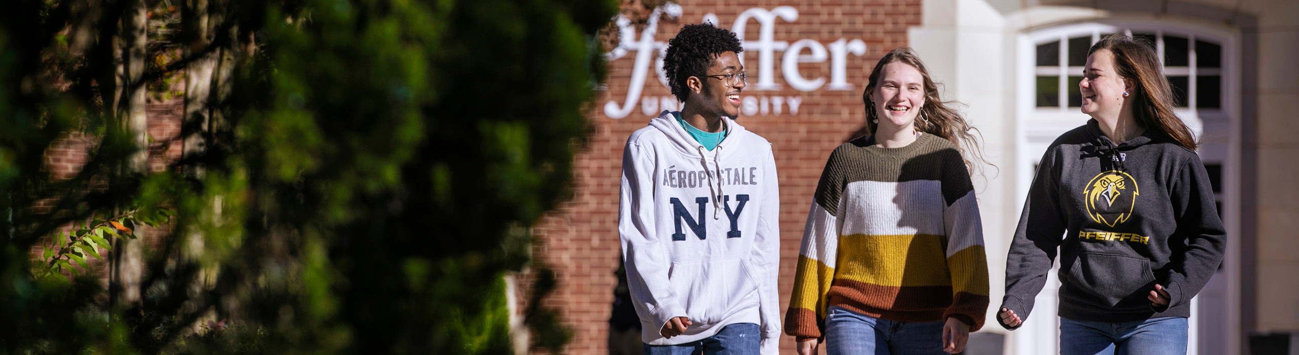 Three students walking on campus