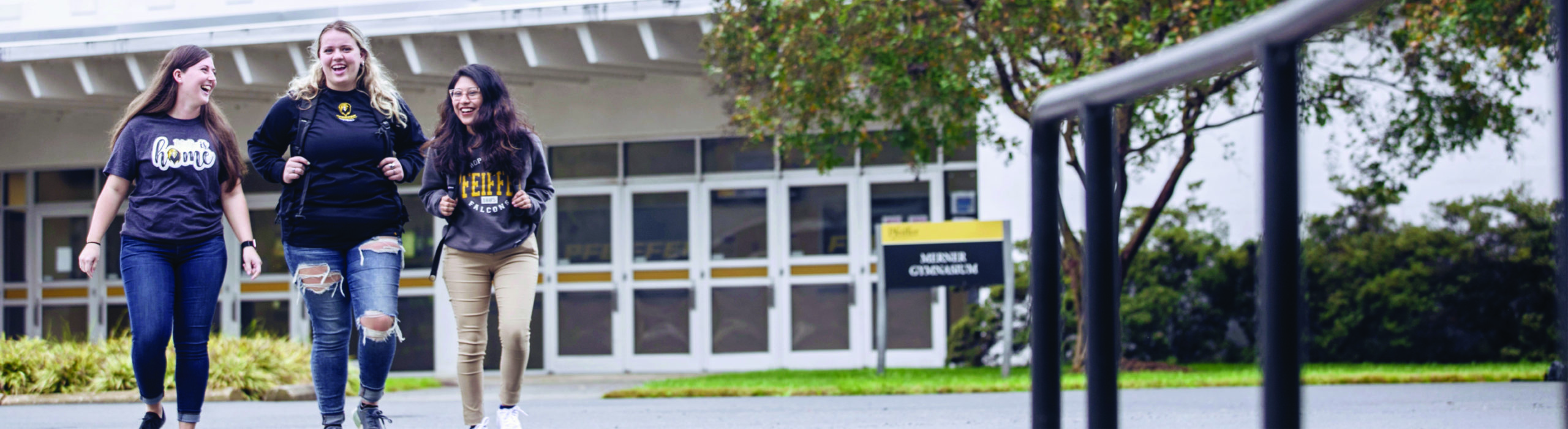 three female students walking outside on campus