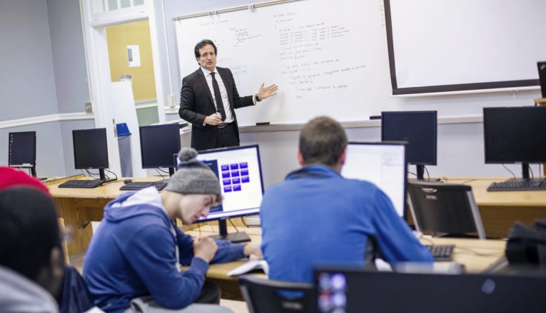 Professor teaching at whiteboard during class