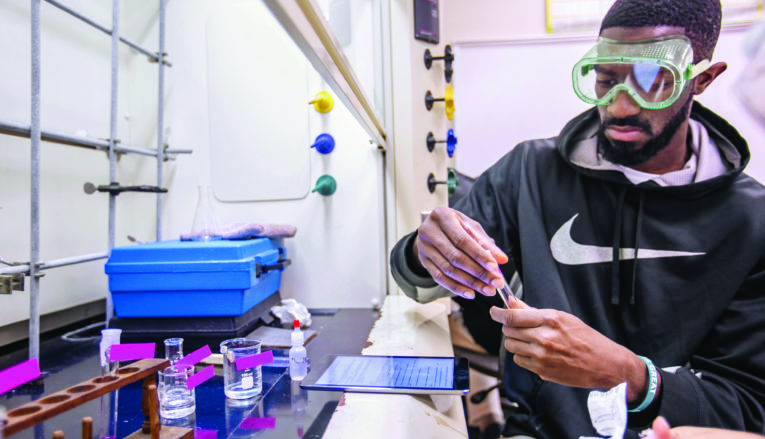 male student working in chemistry lab