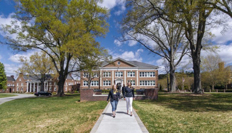 Two students walking outside on Pfeiffer campus