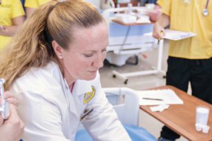 Nursing instructor and students in lab