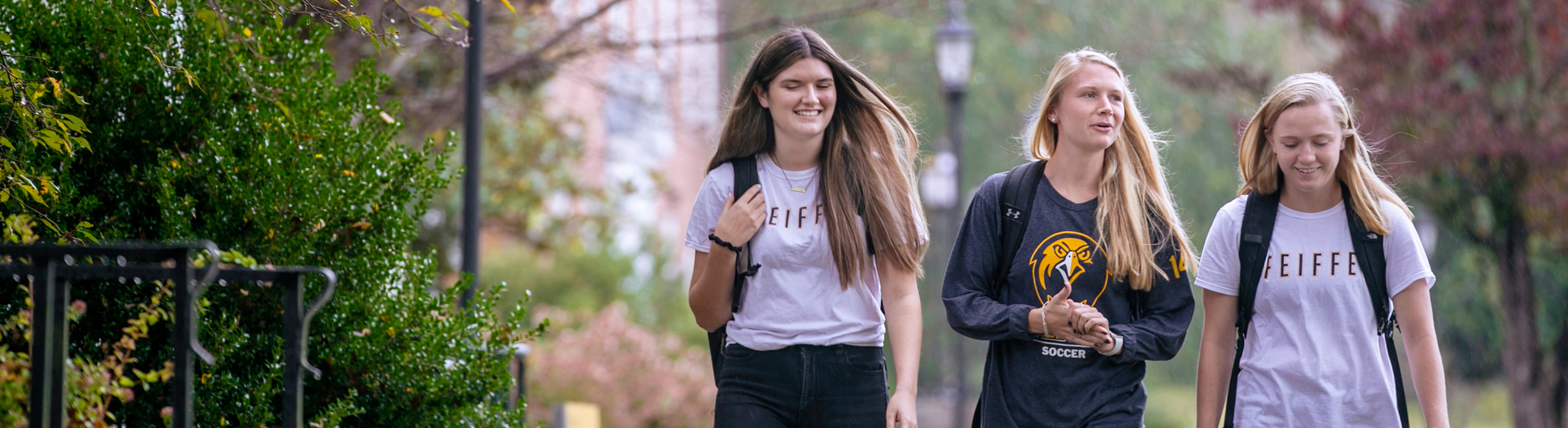 Three students walking outside