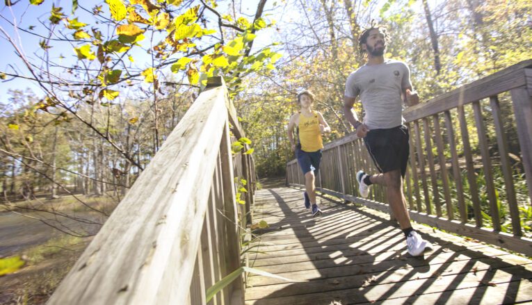 Two young men jogging outside