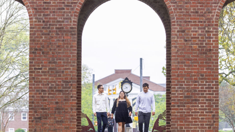 Students walking through Arch